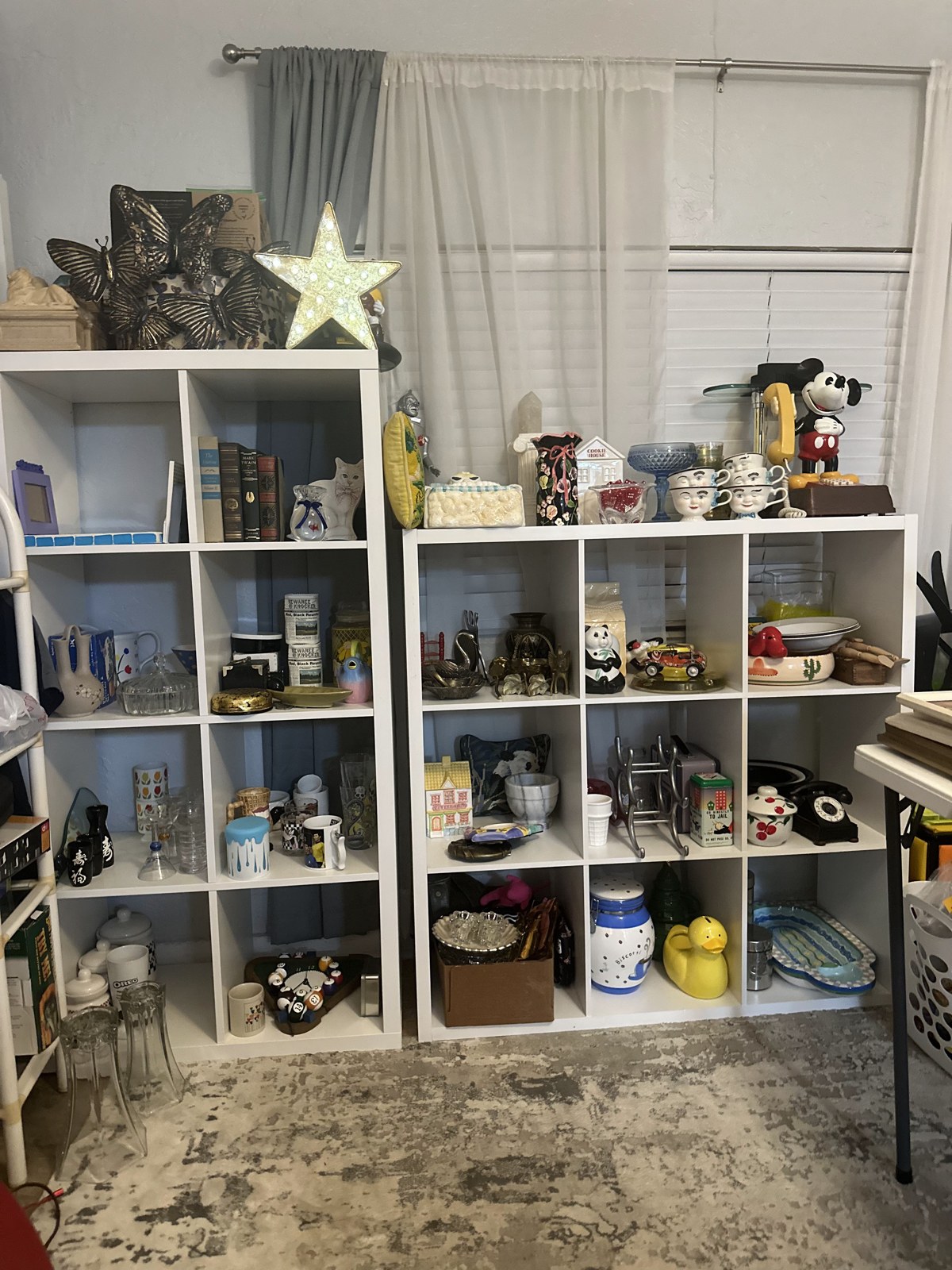 Vintage pieces displayed on white shelves in the October 2023 apartment