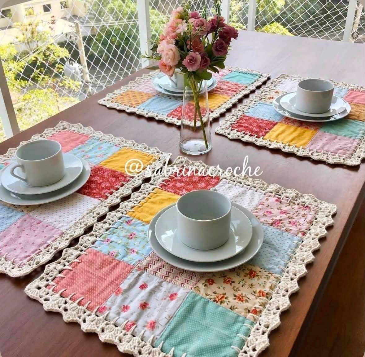 Pastel patchwork placemats with crochet borders on a dining table
