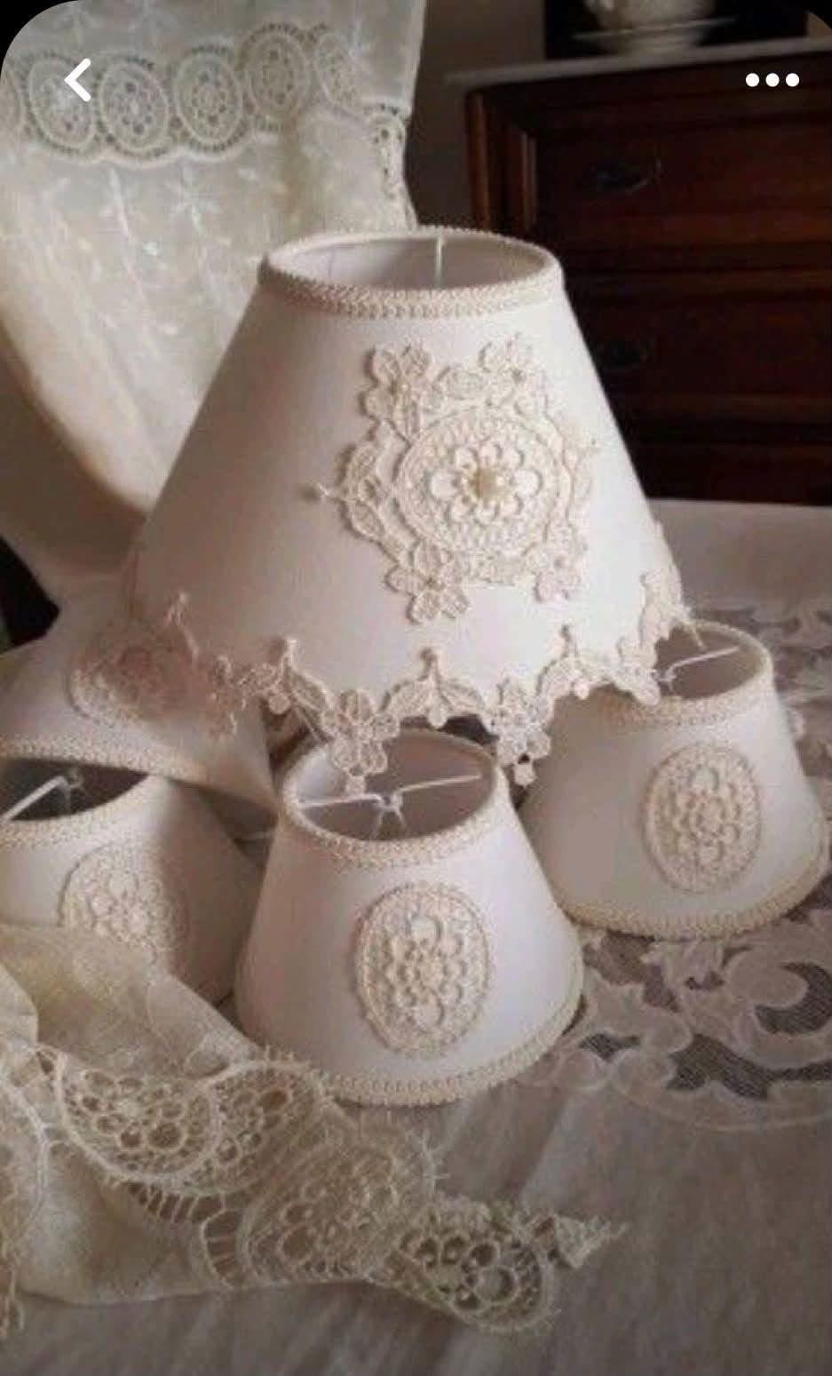 Cream lampshades decorated with doilies and lace trim
