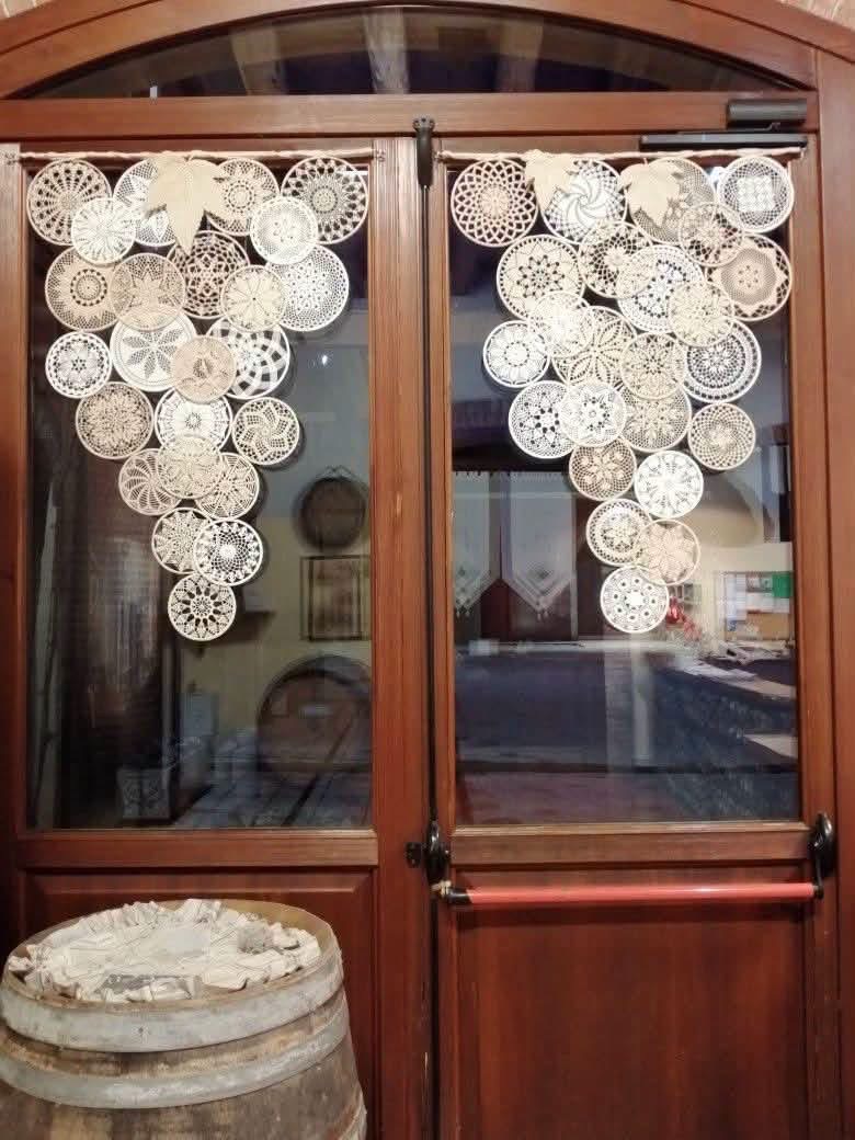 Doily curtains decorating two wooden framed glass doors