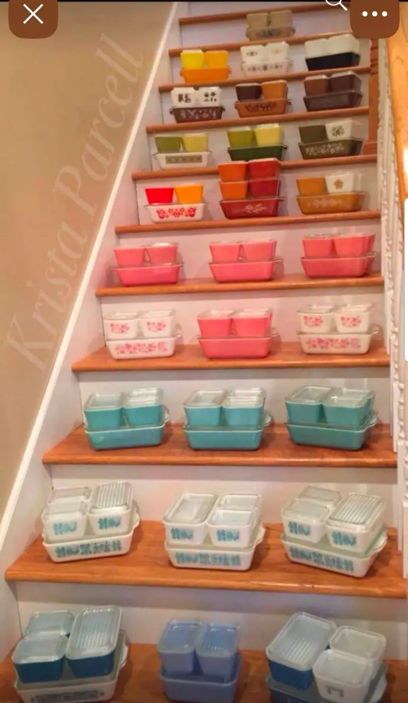 Colorful Pyrex refrigerator dishes arranged on staircase steps