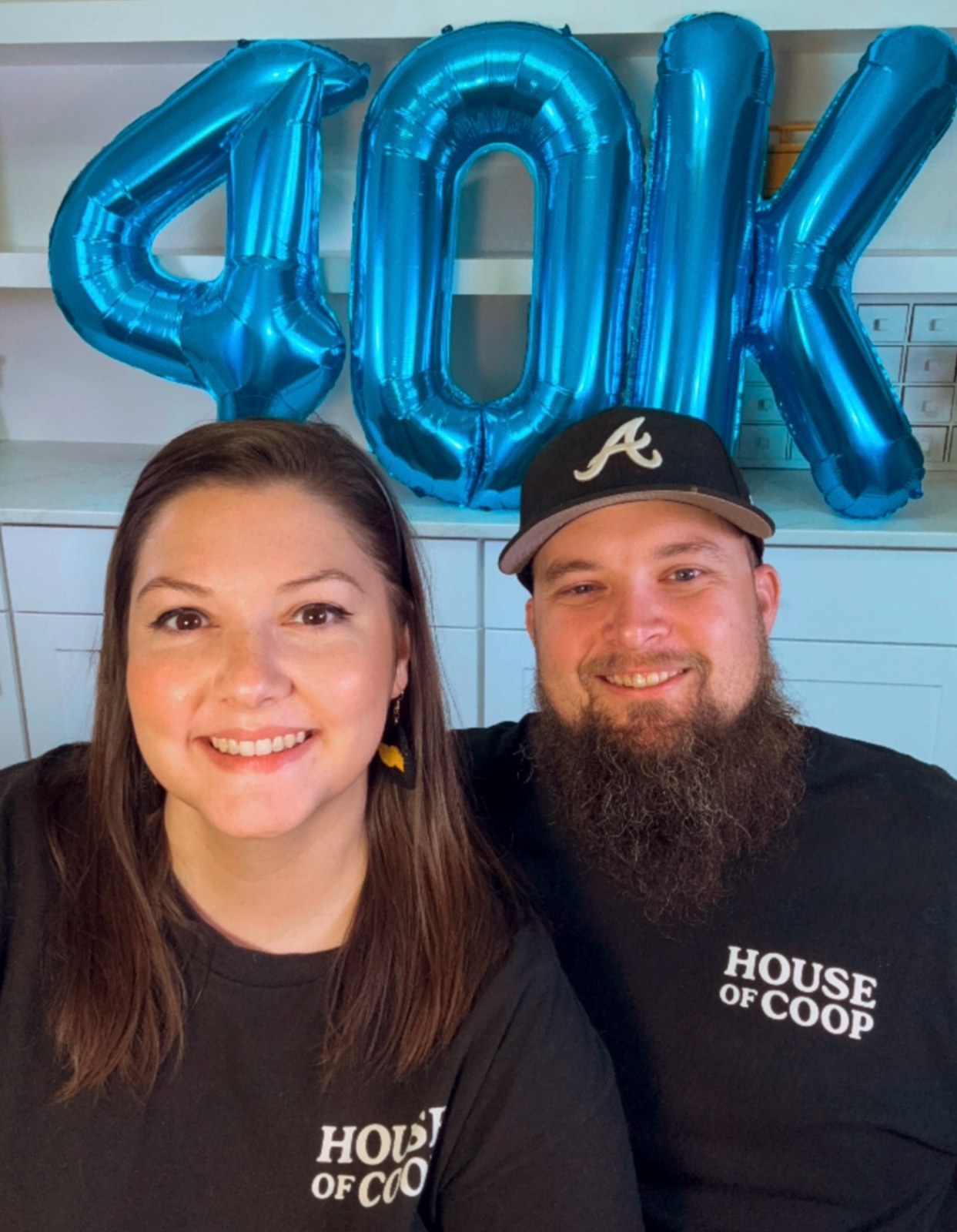 Ashley and Jacob celebrating 40,000 Whatnot friends beneath blue 40K balloons