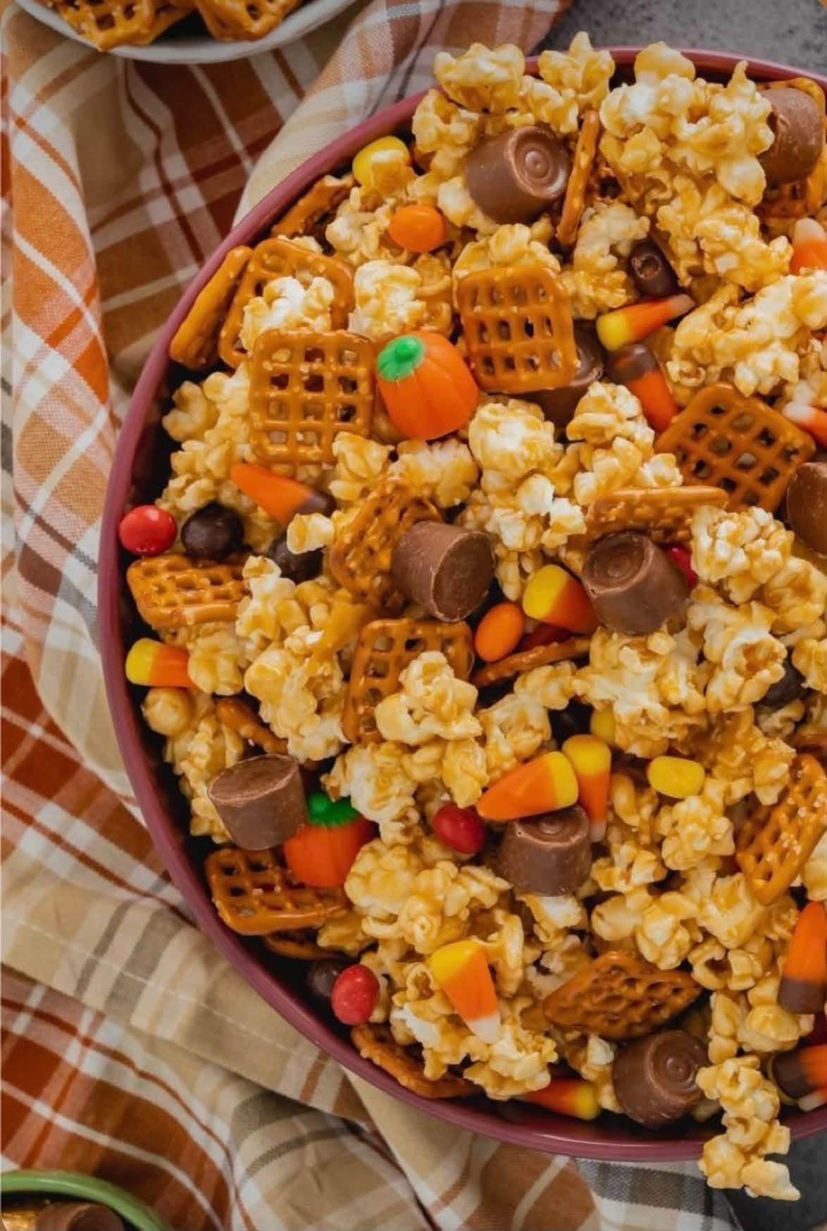 Autumn snack mix with popcorn, pretzels, candy corn, and chocolate