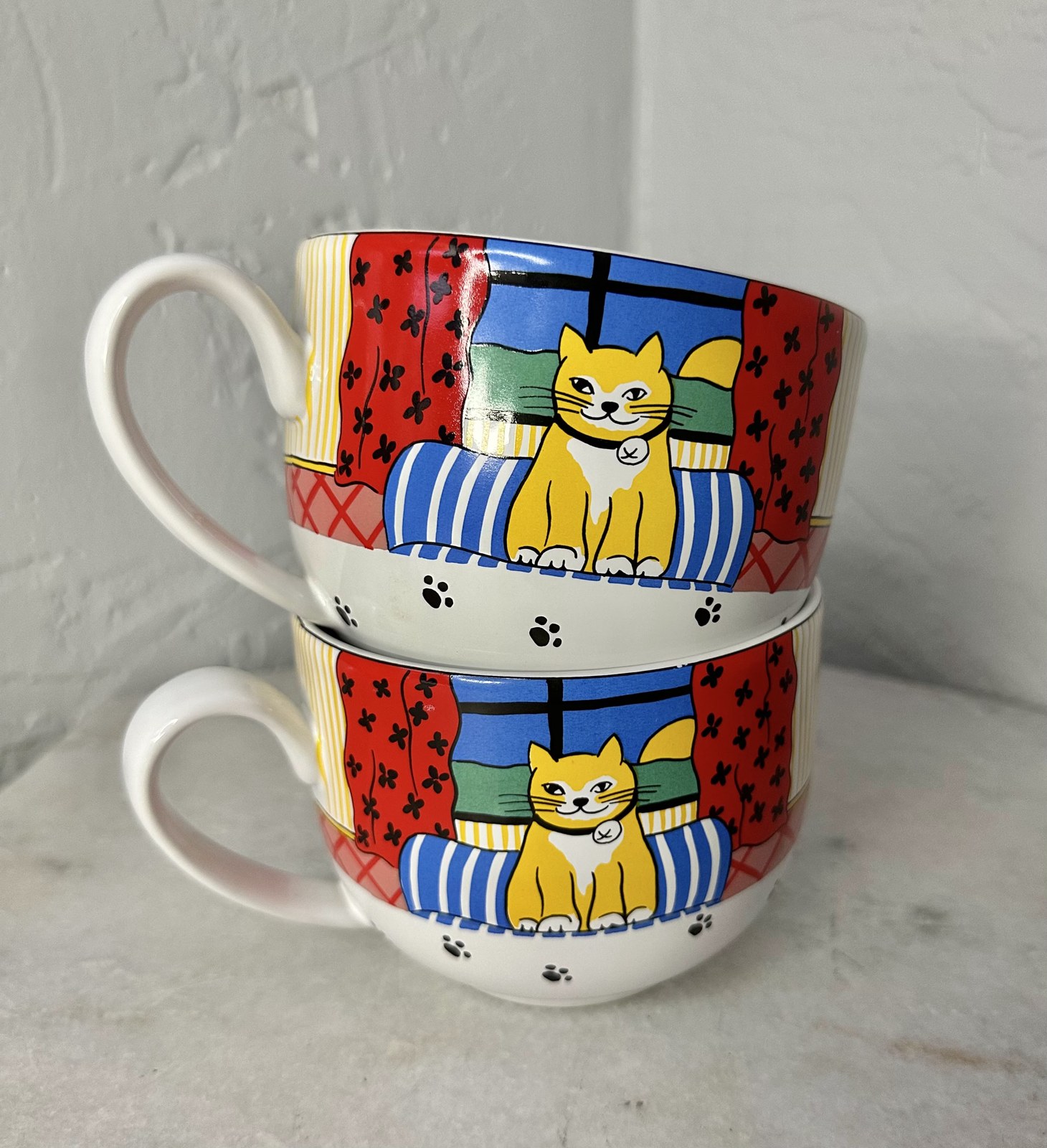 Stacked colorful cat mugs