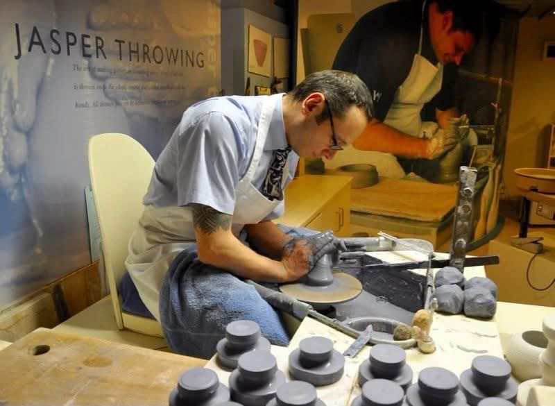 Potter shaping a vessel on a wheel in a Jasper throwing demonstration