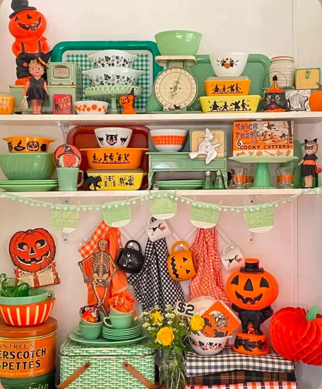 Halloween kitchen display with orange bowls and green dishes