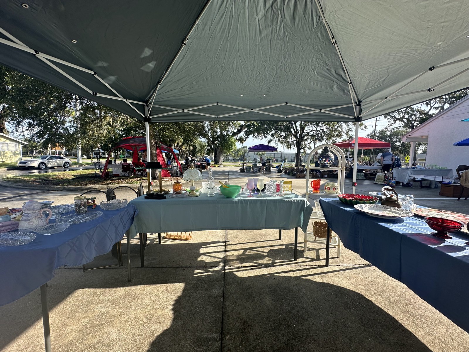 House of Coop’s outdoor vintage-market tables under a canopy
