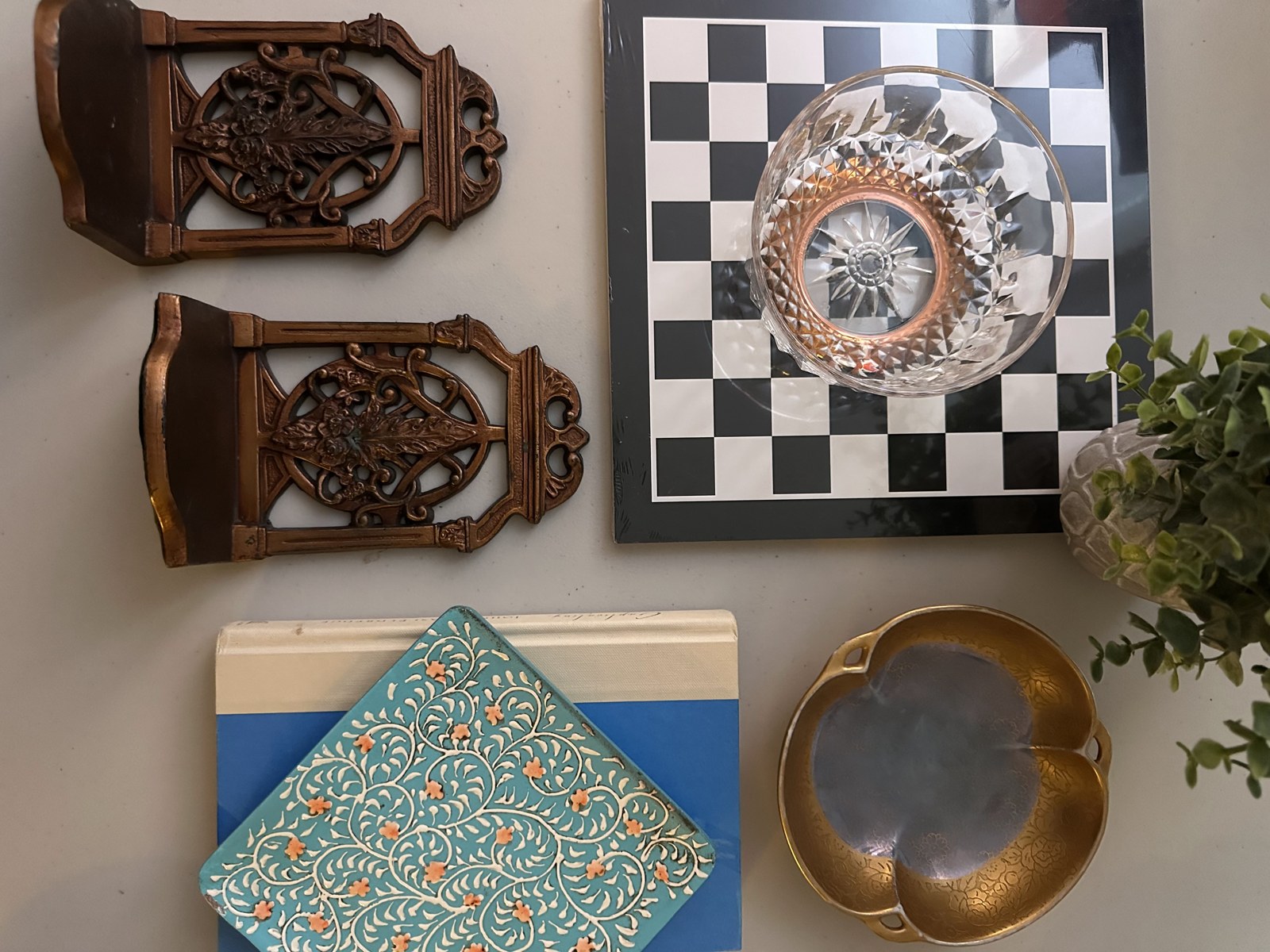 Thrifted wall decor, framed artwork and vintage accents arranged on a table