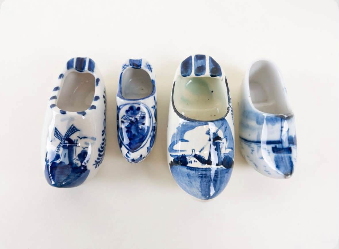 Four miniature blue and white ceramic shoes