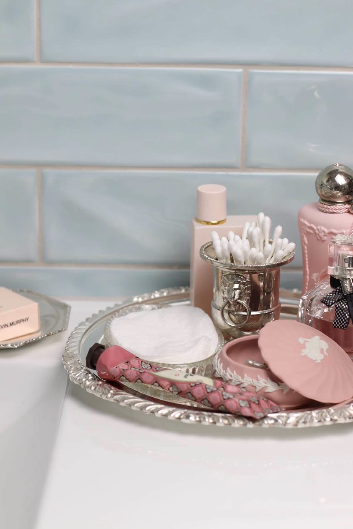 Pink relief-decorated box on a silver vanity tray