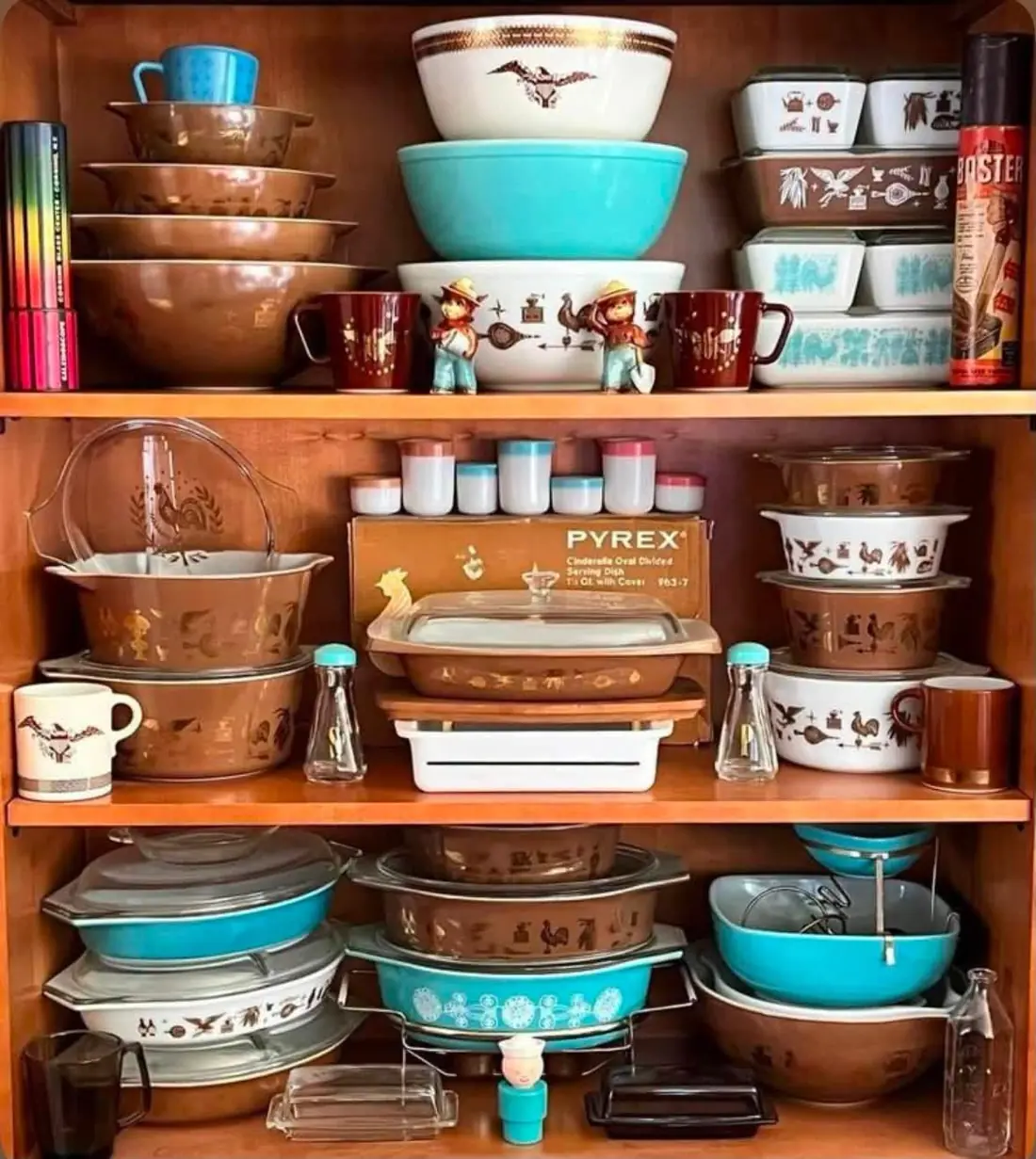 Brown and turquoise Pyrex on wooden shelves