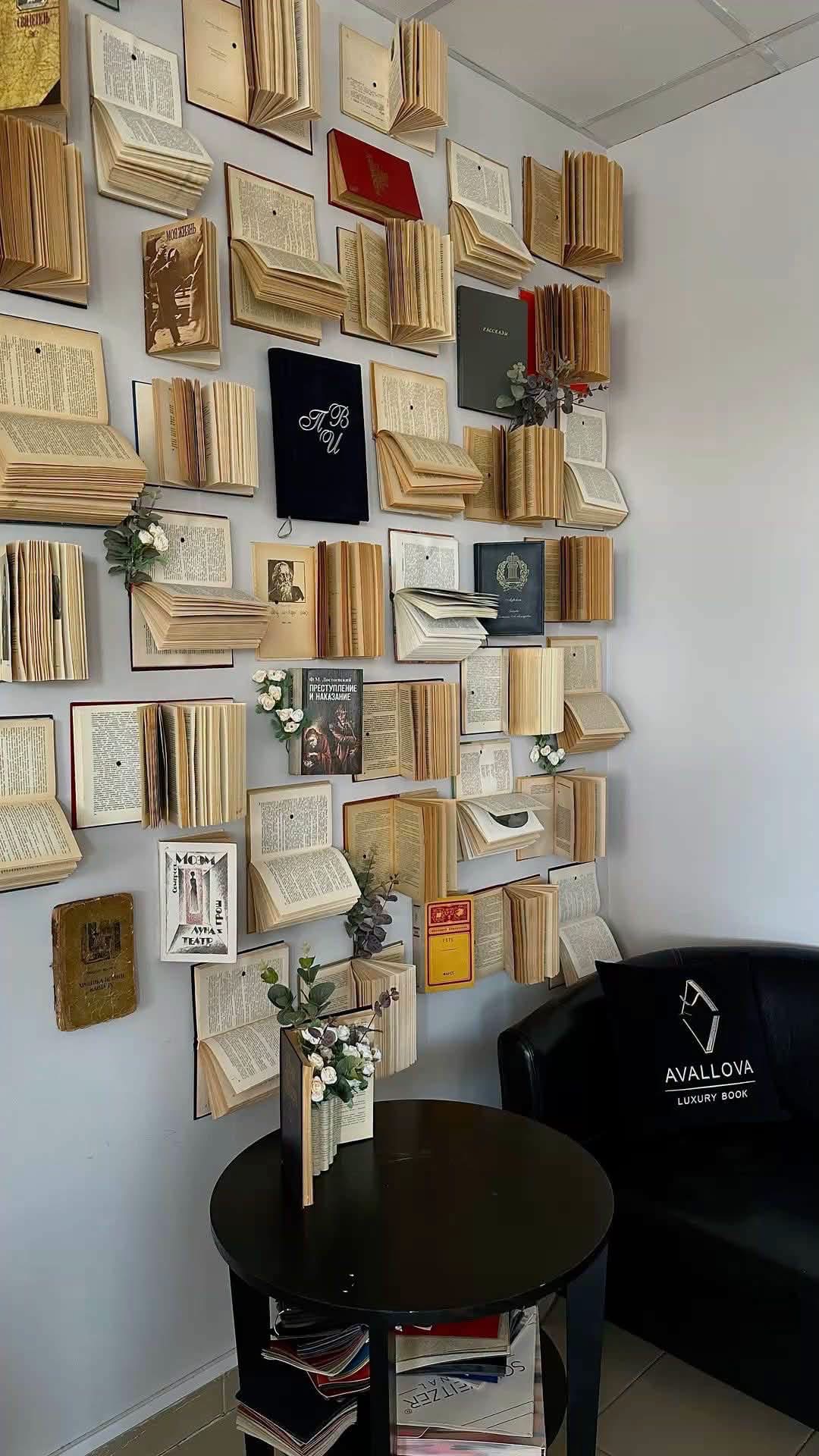 Open books arranged as wall art beside a reading corner