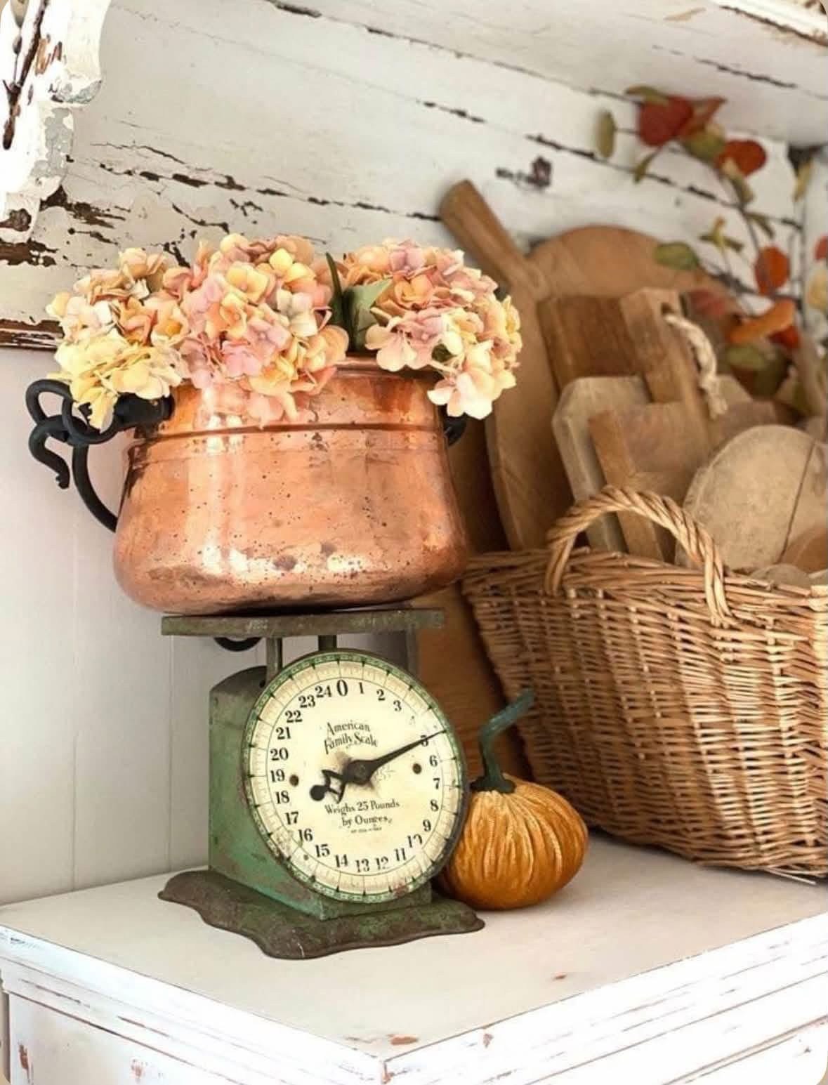 Copper pot of hydrangeas on a vintage green kitchen scale